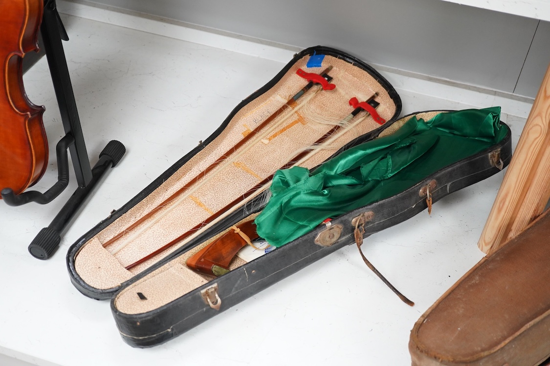 A cased late 19th century German Mittenwald violin with lion’s head scroll, and two bows, Ivory submission ref: RP2E5HT1